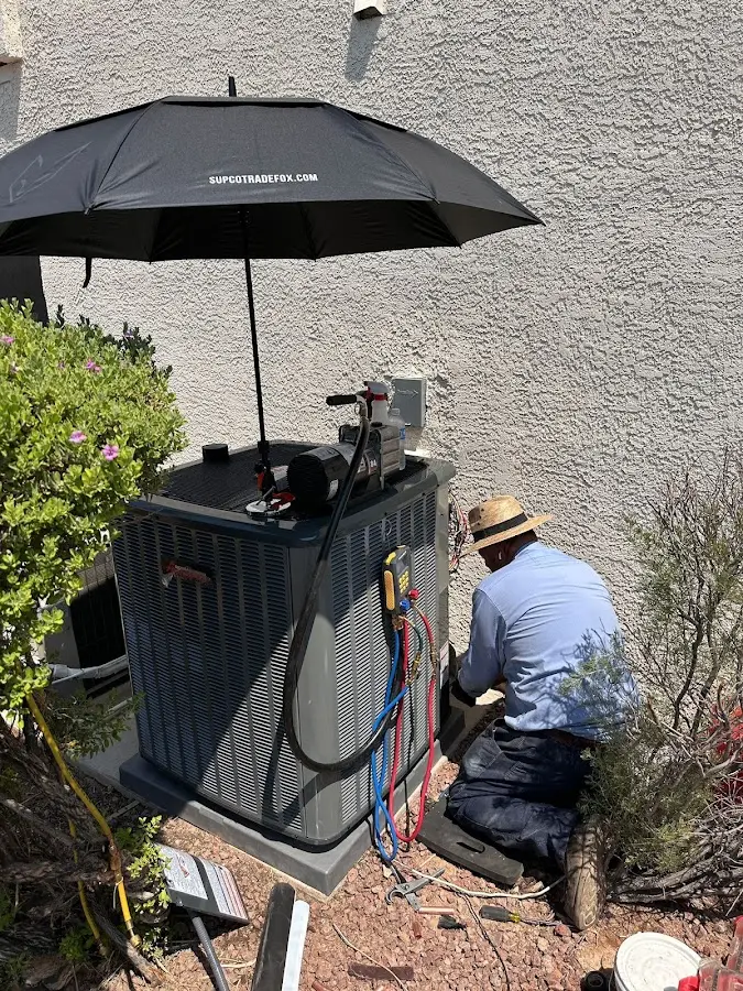 HVAC technician performing outdoor AC maintenance in Spearfish